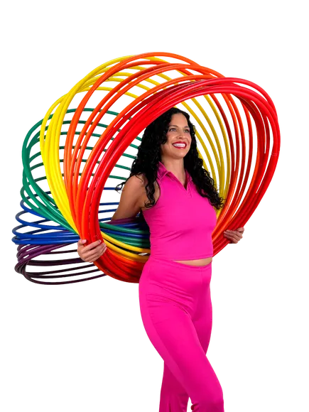A performer joyfully spinning a rainbow of hula hoops